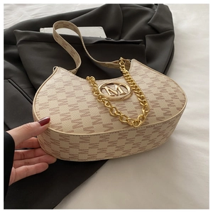Macro detail of beige hobo bag with M-letter print and gold circular metal logo