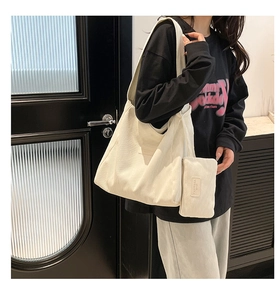Detail of white corduroy tote bag with texture surface and PANYISSA logo branding
