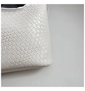 Detailed view of the woven white leather texture and artisan Intrecciato craftsmanship