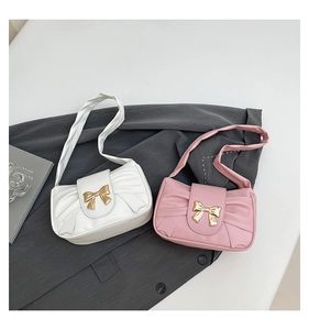 Detail of pleated bow shoulder bags in white and pink with gold metal bow clasp
