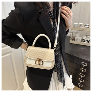 Détail du sac bandoulière en paille et cuir blanc avec poignée dorée et fermoir en T doré
