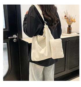 Detail of white corduroy tote bag set with matching zipper pouch and texture close-up