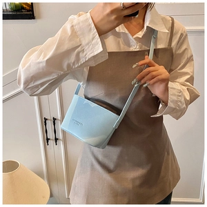 Detail of light blue lychee pattern leather bucket bag with FASHION & BAGS text