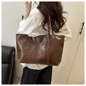 Detail of vintage dark brown faux leather tote bag with elegant rectangular stitching
