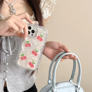 Detail of iPhone case featuring 3D resin cherries and pearl texture with a bow design