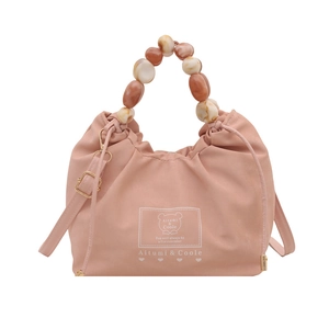 Chic peach pink dumpling bag with marble beaded handle and adjustable shoulder strap