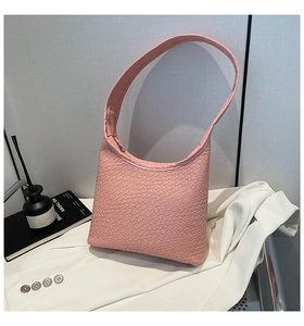 Detail of pink woven hobo bag showing intricate crisscross leather texture and zip closure