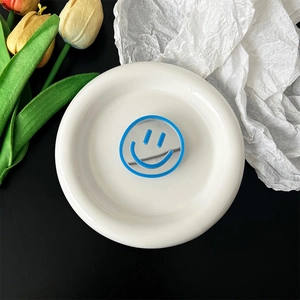 Detailed close-up of a blue smiley face mirror phone grip stand with tulip decor