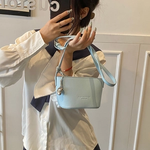 Light blue lychee texture bucket bag with adjustable strap and heart charm