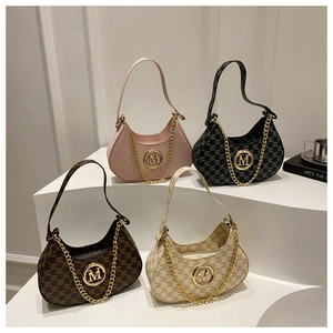 Detail of four hobo bags with metallic M logo and chunky gold chain decoration