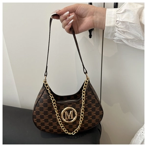 Detailed close-up of dark brown hobo bag with M-letter print and gold metal logo