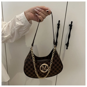 Detail of dark brown monogram hobo bag with gold M logo and chunky metal chain decoration