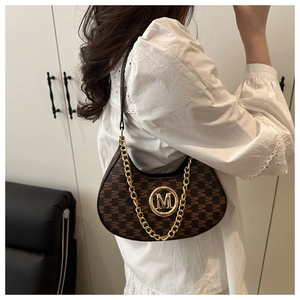 Close-up of brown monogram hobo bag with gold metal M-logo and chunky chain strap