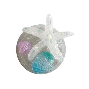 Glittering seashell and starfish phone socket holder with a dreamy ocean theme design