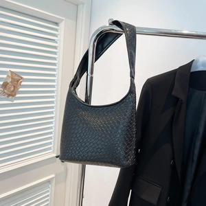 Retro black woven hobo shoulder bag with wide strap displayed on a metal hanger