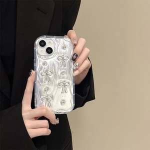 Detail of silver glitter iPhone case with 3D metallic bows and sparkling rhinestones