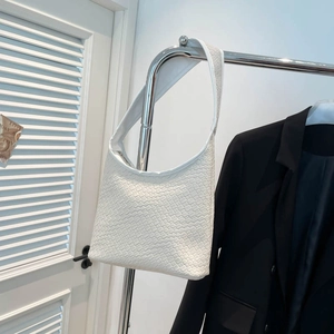 Retro large capacity white woven bucket bag with wide shoulder strap on silver hanger