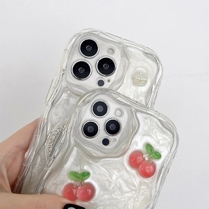 Detail of pearl white wavy phone case with 3D cherry and rhinestone decorations