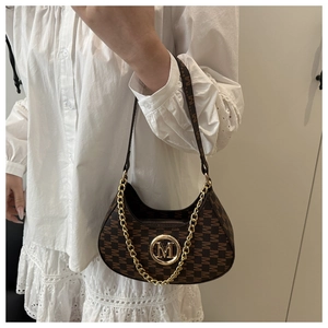 Detail of a brown crescent shoulder bag with M letter pattern and gold chain strap