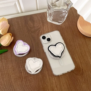 Detail view of heart-shaped Magsafe phone grips with mirrors in purple black and white