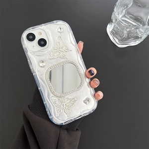 Close-up of glitter iPhone case featuring silver butterflies and a rhinestone vanity mirror