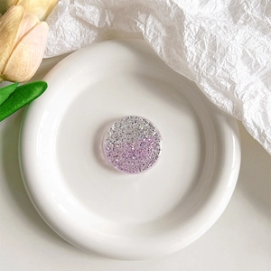 Vue macro d'un support de téléphone pailleté rond avec dégradé de résine violet et argent