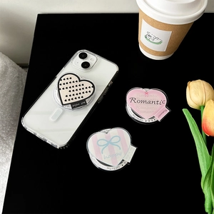 Detail view of heart-shaped magnetic MagSafe phone grips with cute romantic patterns