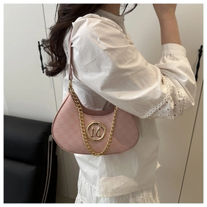 Pink crescent underarm bag detail featuring gold M buckle and chic chain strap