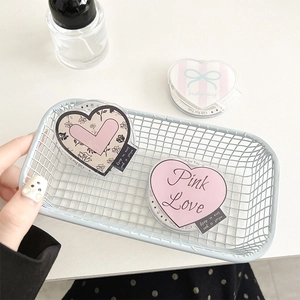 Detail of pink acrylic heart MagSafe phone grip with bow and floral patterns