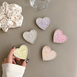 Macro shot of glitter heart phone sockets with rhinestone edges in various pastel colors