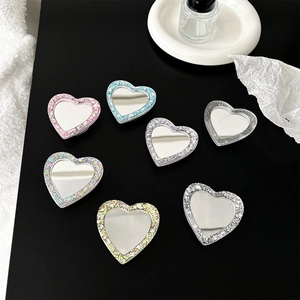 Sparkly heart-shaped mirror phone grips set in various glittery colors for women