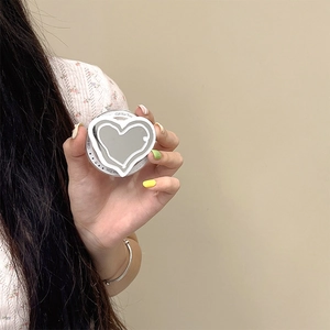 Detail of heart-shaped mirror Magsafe grip with Gift For You text held by a model