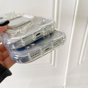 Detailed bottom view of clear wavy case with silver butterfly and rhinestone accents