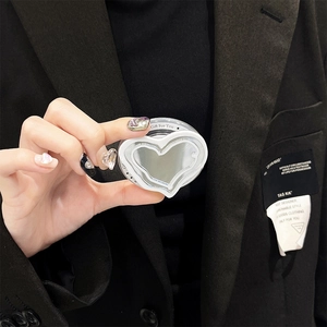 Detail of white heart-shaped MagSafe mirror phone grip with Gift For You print