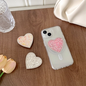 Sparkly rhinestone heart phone sockets on a wooden desk with elegant tulip decor