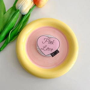 Detail of pink heart Magsafe phone grip with Pink Love text on a ceramic jewelry tray