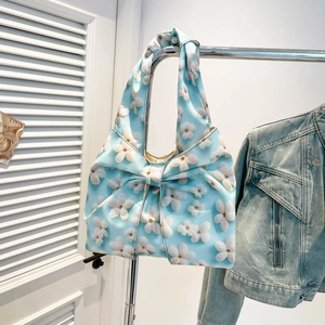 Light blue bow shoulder bag with white floral prints on lightweight fabric fabric