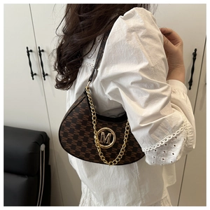 Detail of vintage brown monogram crescent bag with gold chain and M logo buckle