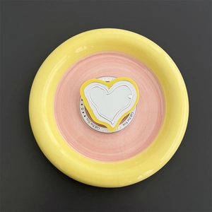 Macro shot of yellow heart MagSafe phone grip with acrylic mirror and Gift For You text