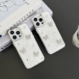 White marble pattern iPhone case with silver rhinestone butterfly design and metallic edges