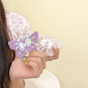 Detail of handmade bead-woven butterfly phone grip with sparkling rhinestones and crystals