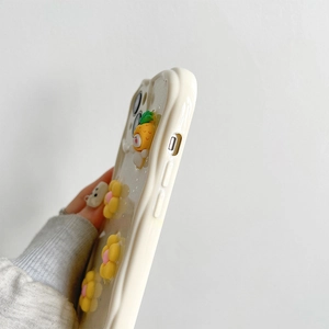 Detail view of wavy edge phone case with 3D yellow flower and cute pineapple doll