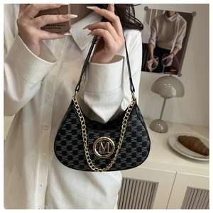 Detail of black monogram crescent bag with golden metal M logo and chic chain strap