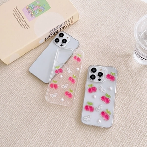 Cute iPhone case with pink cherries, white bow, and pearls on a clear background