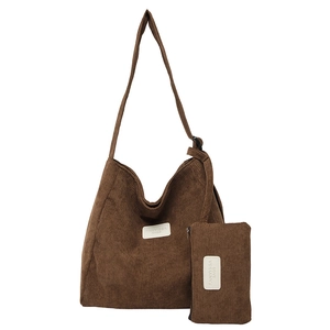 Brown corduroy shoulder tote bag with adjustable strap and small matching zipper pouch