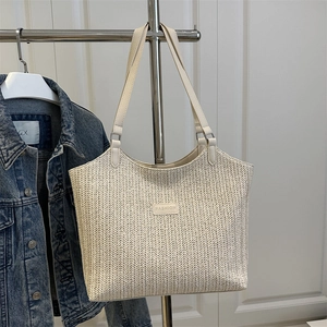 Retro woven beige tote bag with leather straps and Fashion logo on white background