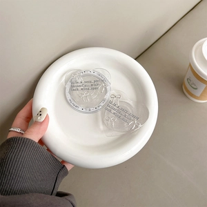 Macro detail of heart-shaped glitter phone grips with bow pattern and text in a tray