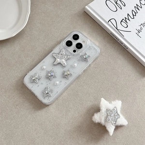 Detail of iPhone case with silver glitter stars, pearls and a plush star phone socket