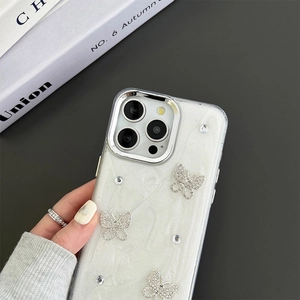 Macro view of iPhone case with shiny glitter texture and 3D rhinestone butterfly decor