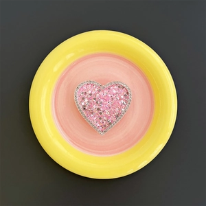 Macro shot of heart-shaped phone grip with pink glitter and sparkling crystal rhinestones